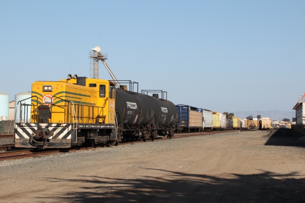 70T pulls freight train in yard